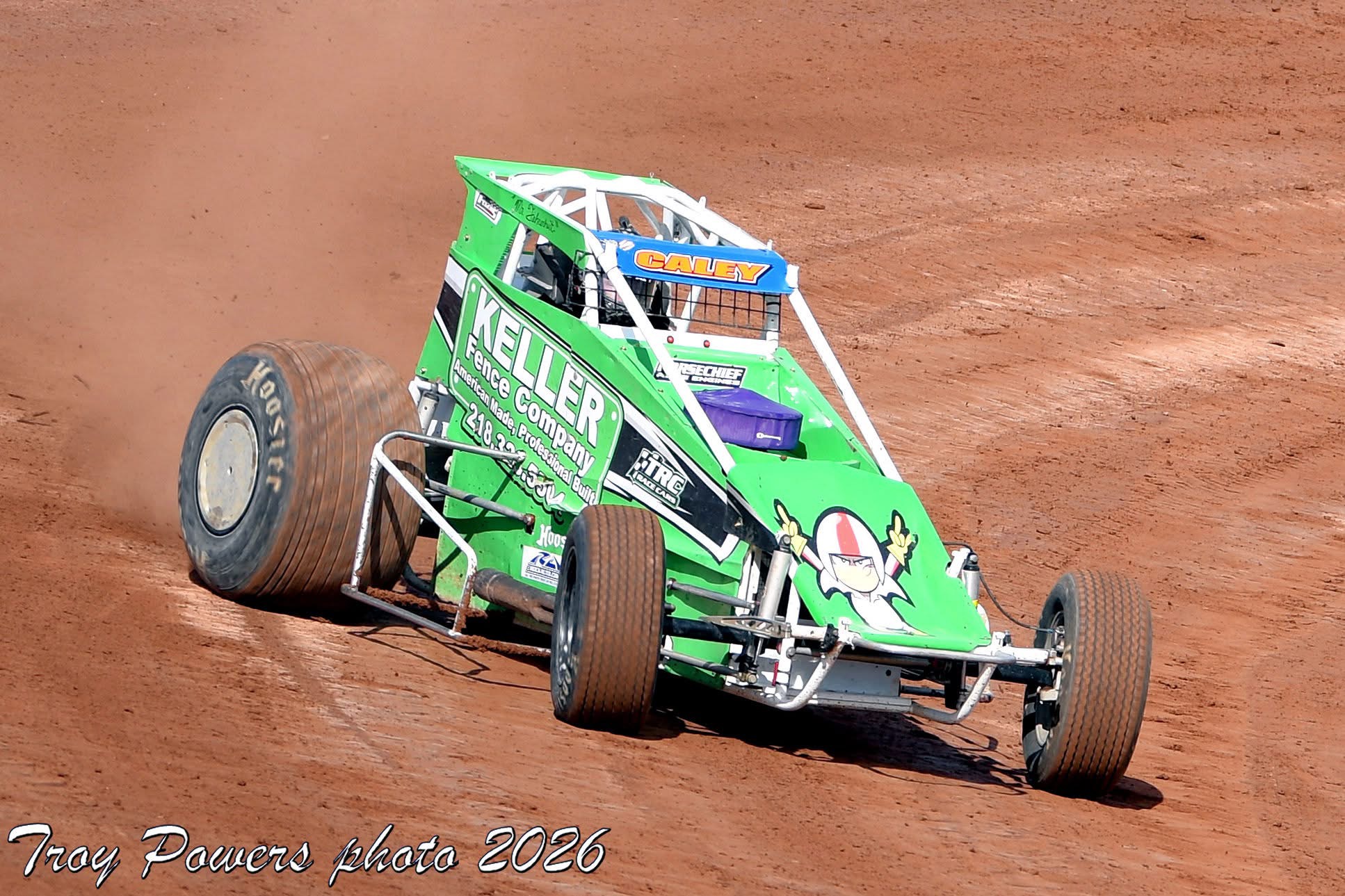 Green sprint car racing on dirt