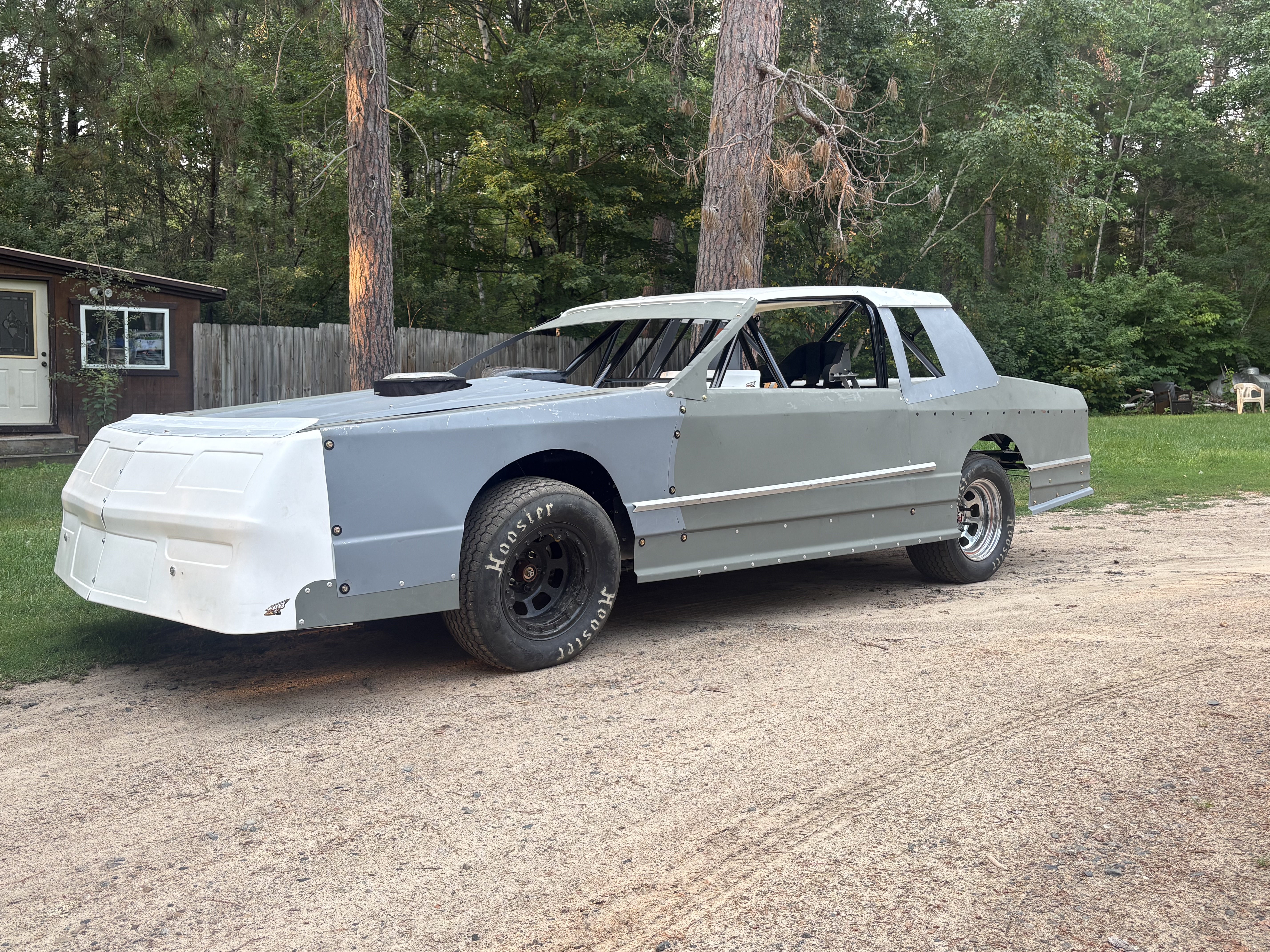 Gray Street Stock with body installed, left-front three-quarter view outside the shop