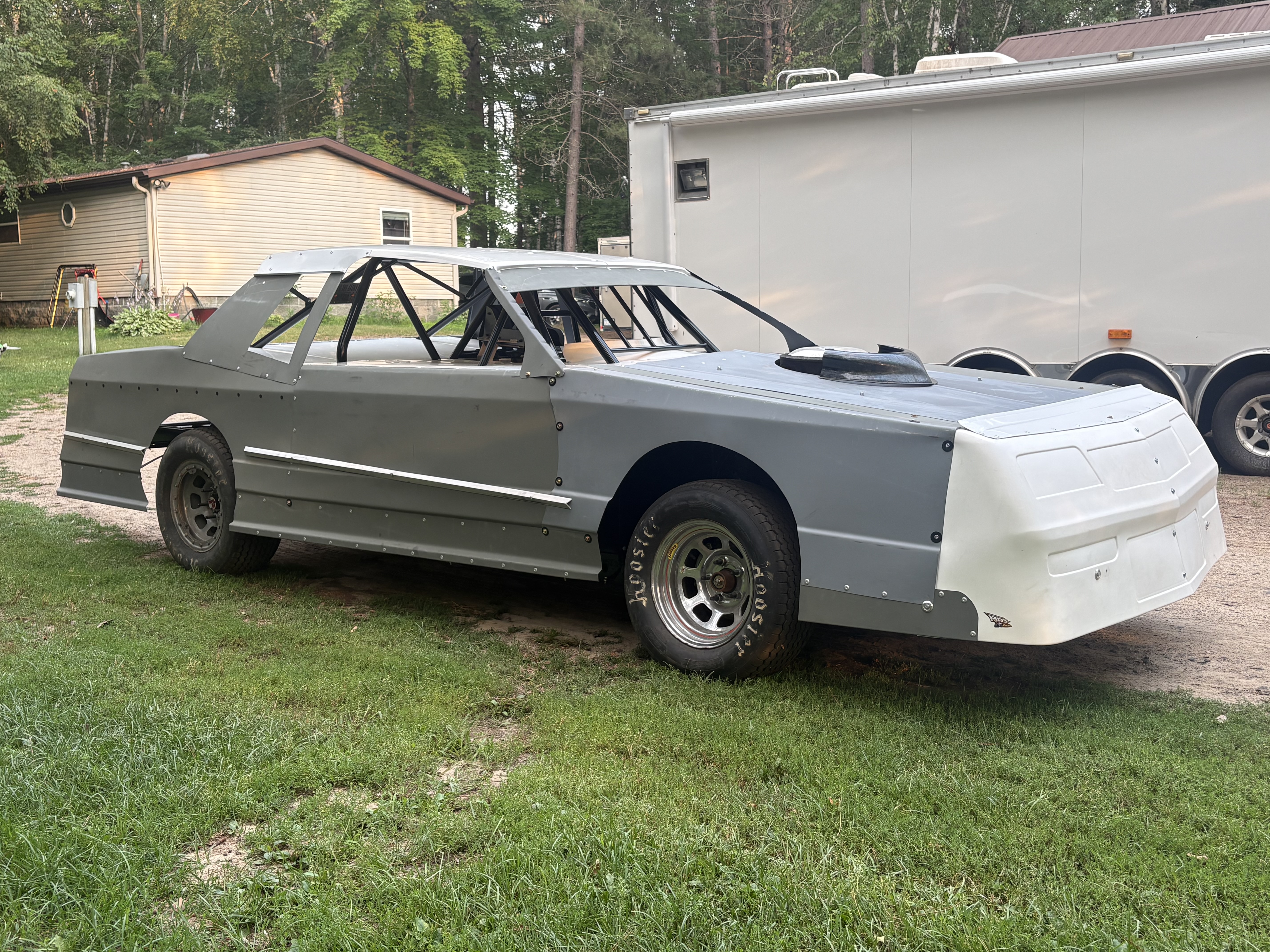 Gray Street Stock with body installed, right-front three-quarter view outside the shop