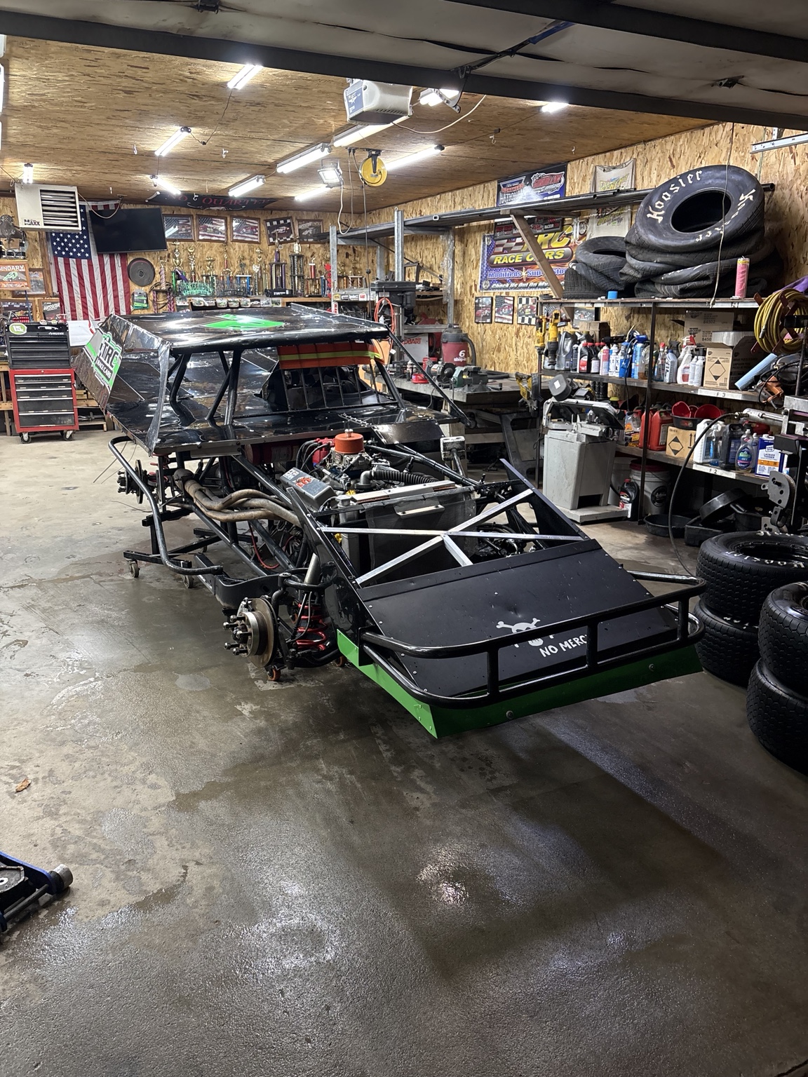 Modified race car undergoing workshop preparation
