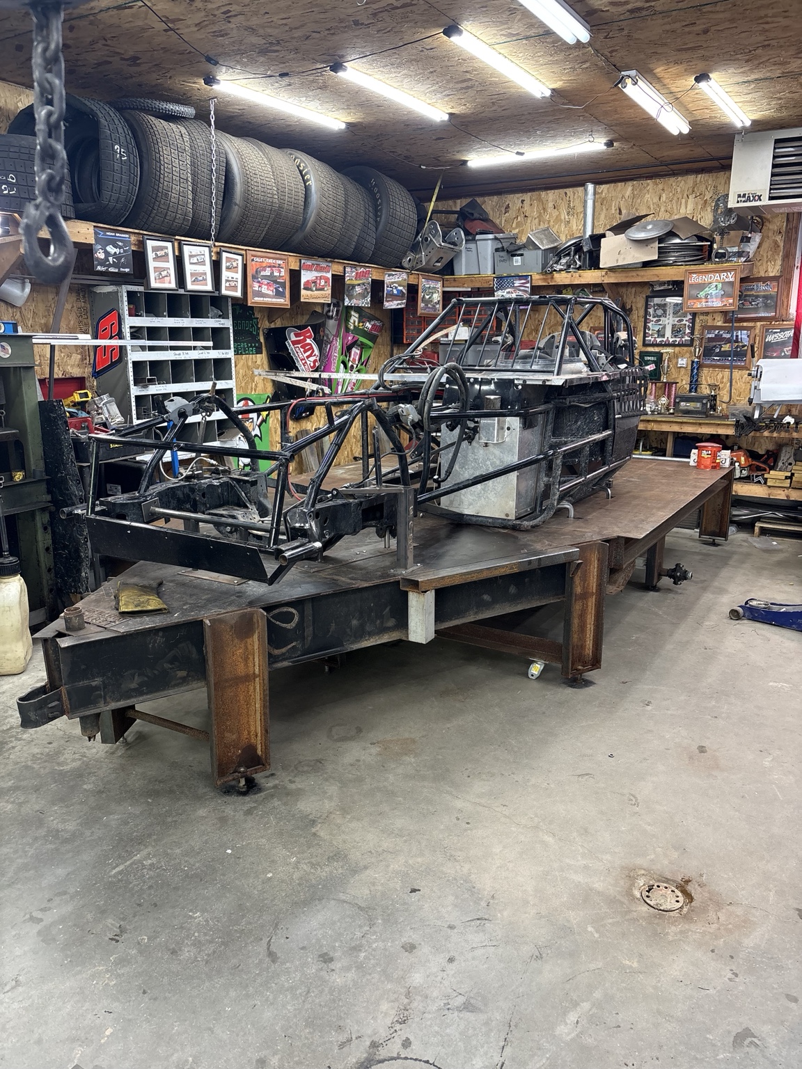 Bare racing chassis on a fabrication table